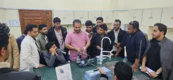 Civil engineering students conduct a practical experiment to measure drinking water quality during a scientific visit to the health laboratory at the University of Science and Technology.